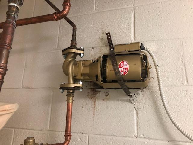 A close up of a water heater attached to a wall