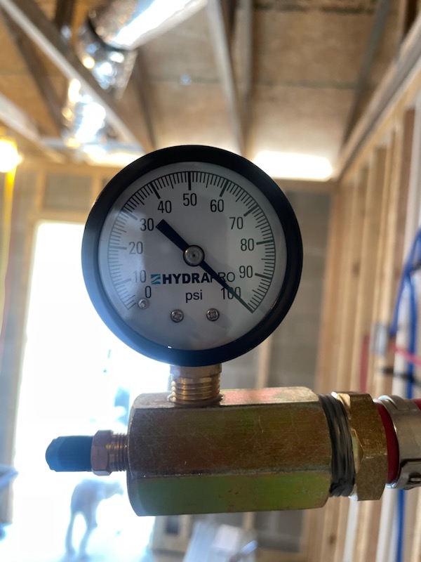 A close up of a pressure gauge on a pipe