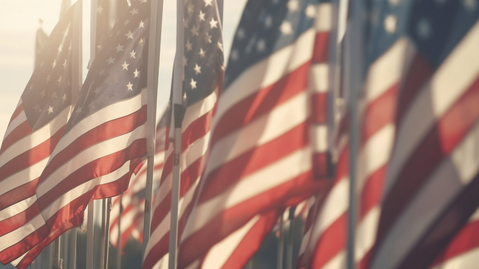 A bunch of american flags blowing in the wind